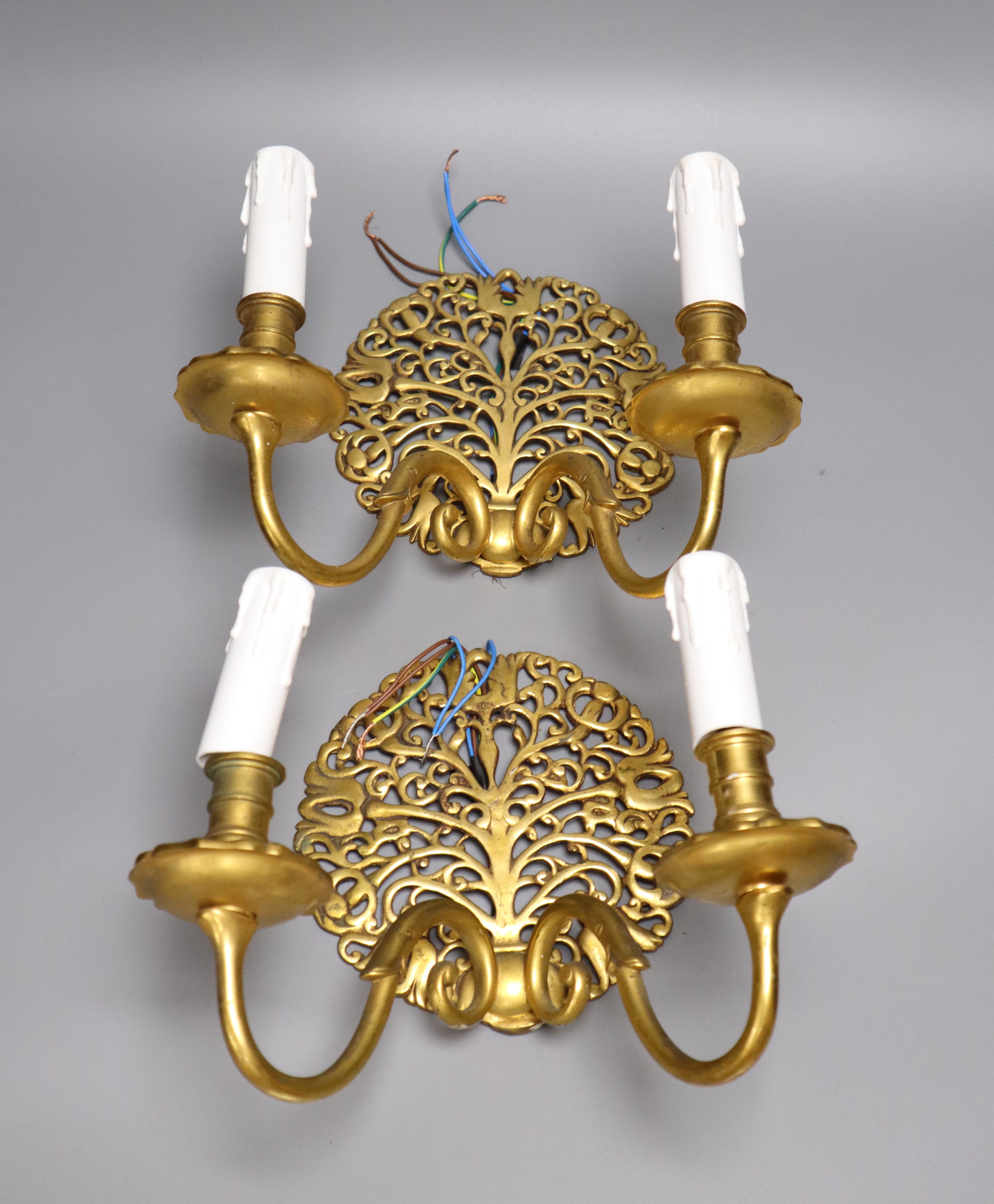 A pair of gilt brass twin-light wall sconces, height 22cm